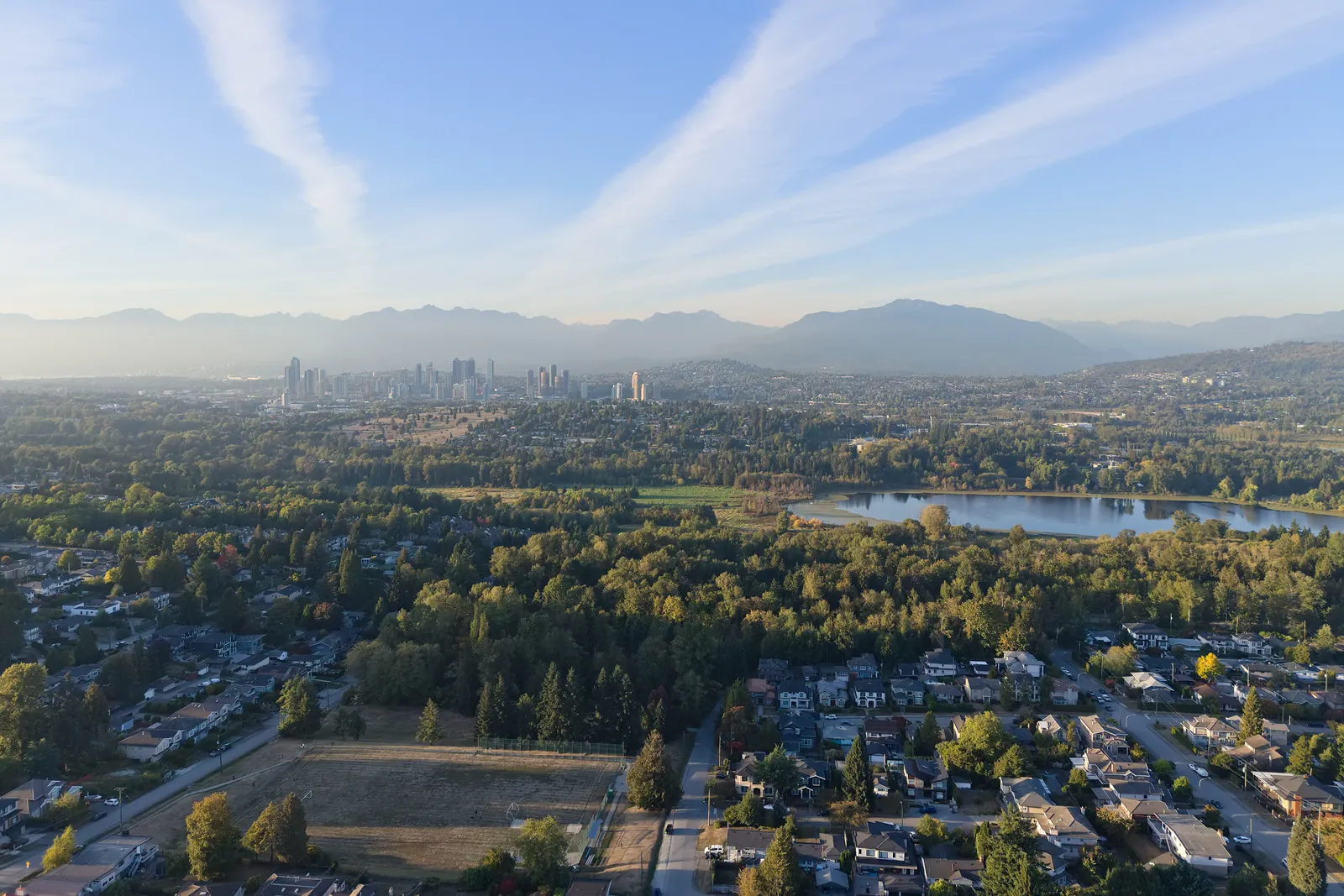 Deer Lake with the surrounding park and neighbourhoods in Burnaby, and the North Shore mountains behind